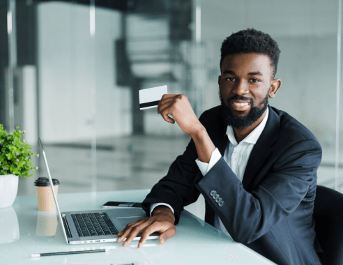 Businessman holding business card at desk